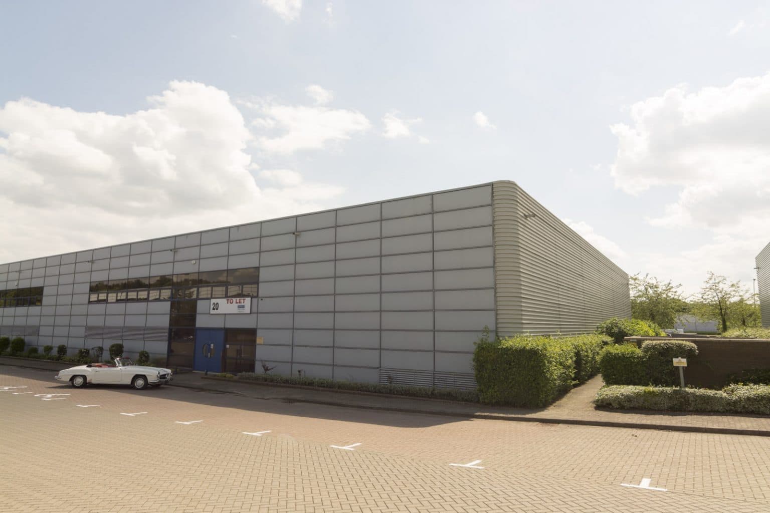 Mercedes 190SL parked outside new potential warehouse unit